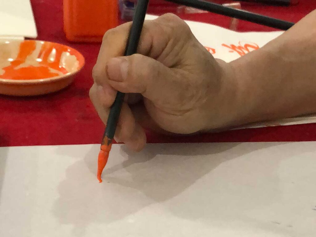 筆を持つ先生の手